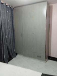 two gray cabinets in a room with a curtain at Leilani Homes in Kajiado