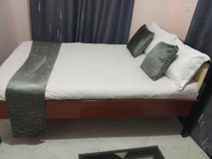 a bed with two pillows on it in a room at Leilani Homes in Kajiado