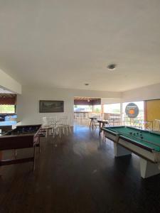 Habitación con mesa de billar, mesas y sillas en Mansão Fazendinha para grupos Arraial do Cabo, en Arraial do Cabo