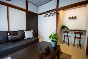 a living room with a couch and a table at M&T stay in Tokyo