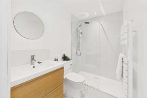 a white bathroom with a sink and a shower at Host & Stay - The Surf Shack in Saltburn-by-the-Sea