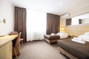 Postel nebo postele na pokoji v ubytování Hotel Boss