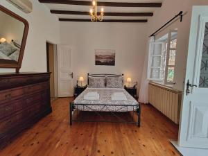 a bedroom with a bed in the middle of a room at Flora's House in Hydra