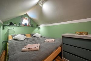 a bedroom with a bed with two towels on it at Bakino brdo - Granny's hill in Bakovčica +46 photos