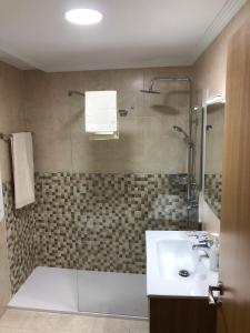 a bathroom with a tub and a sink and a shower at El apartamento de la catedral in Burgos