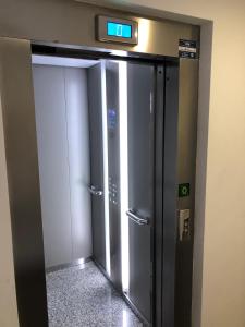 an elevator door with a clock on the wall at El apartamento de la catedral in Burgos