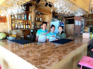 a group of people standing at a bar at Balai Ko Beach & Cottages in El Nido