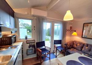 a kitchen and living room with a couch and a table at Tofte Guesthouse nära hav, bad och Marstrand in Lycke +13 photos