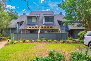 a house with a fence in front of a yard at Spacious 2 Bedroom Condo- Vaulted Ceilings and Fireplace- St James Park 12-E in Myrtle Beach