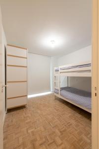 a room with two bunk beds and a wooden floor at -Stay- at Oostduinkerke in Oostduinkerke
