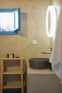 a bathroom with a black sink and a mirror at Apleton Beach House Kimolos at Zacharias Beach in Kimolos