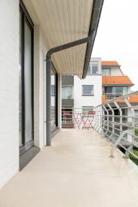 an empty balcony with awning on a building at -Stay- at Oostduinkerke in Oostduinkerke