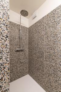 a shower in a bathroom with mosaic tiles at -Stay- at Oostduinkerke in Oostduinkerke +18 photos