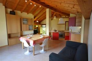 a kitchen with a table and chairs in a room at Casa La Sorgente in Montemezzo