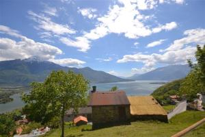 a building on a hill with a view of a lake at Casa La Sorgente in Montemezzo