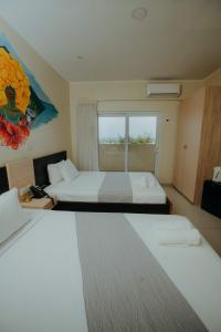 Postel nebo postele na pokoji v ubytování Curacao Airport Hotel + 36 fotografií
