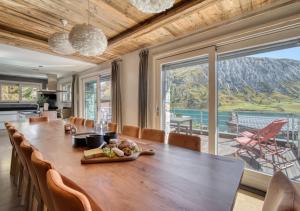 a dining room with a table and a large window at Chalet Ancolie in Tignes