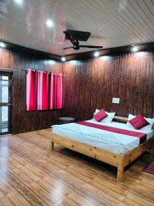 a bedroom with a bed in a wooden wall at Diwan's Homestay in Mukteswar