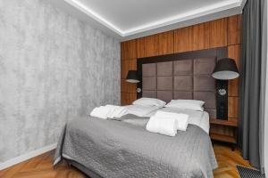 a bedroom with a large bed with white pillows at Amber Apartment Forest View in Stegna +10 photos