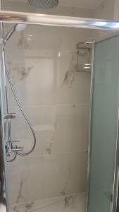 a bathroom with a shower with a glass at Kyra apartment in Polis Chrysochous +11 photos