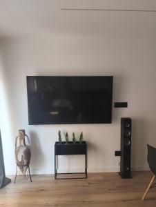 a living room with a flat screen tv on a wall at Vidanova 1 in Vilanova i la Geltrú