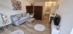 a living room with a couch and a television at Emsquartier Apartment No 1 in Emsdetten