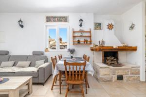 a living room with a couch and a table and a fireplace at Peacefull getaway island Hvar! in Selca kod Starigrada