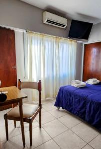 Ένα ή περισσότερα κρεβάτια σε δωμάτιο στο Hotel Cipolletti