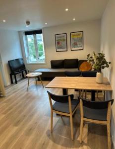 a living room with a table and a couch at Central apartment in Kragerø in Kragerø