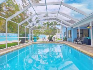 an indoor swimming pool with a pergola and a swimming pool at 5 Bed Heated Pool Largo, Seminole FL 2 mi Indian Rocks Beach , Pets, Game room in Seminole