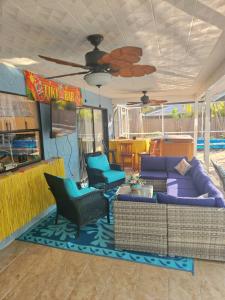 a living room with a couch and chairs and a table at 5 Bed Heated Pool Largo, Seminole FL 2 mi Indian Rocks Beach , Pets, Game room in Seminole +108 photos