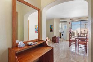 ein Wohnzimmer mit einem Spiegel und einem Esszimmer in der Unterkunft Casa Enxame in Armação de Pêra