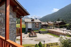 a view from the balcony of a house with a courtyard at Casa Caterina La Thuile in La Thuile