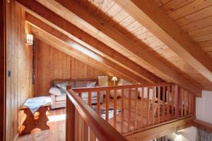 a wooden staircase in a log cabin at Casa Caterina La Thuile in La Thuile