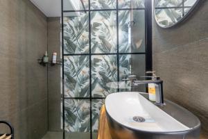 a bathroom with a sink and a shower at Bear Secret House in Ćuprija