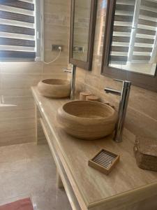 two wooden sinks sitting on a counter in a bathroom at Appartement Centre-Ville Propriano in Propriano