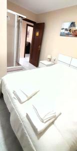 a large white bed in a room with a window at EnViveiro Casco Histórico in Viveiro