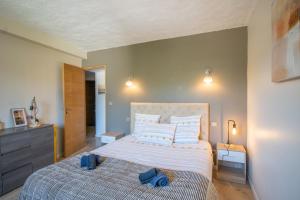 a bedroom with a large bed with blue towels on it at Villa Solsticia in Albitreccia