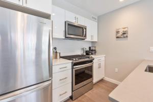 a kitchen with a stainless steel refrigerator and a microwave at Luxury 2BR North End Retreat in Boston