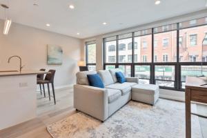 a living room with a couch and a table at Luxury 2BR North End Retreat in Boston