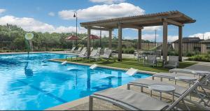 a swimming pool with chairs and a gazebo at Modern Western 5BR Retreat! BMT SeaWorld Riverwalk Alamo in Von Ormy