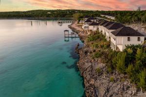 an aerial view of a house on the water at French Leave Resort, Autograph Collection in Governorʼs Harbour