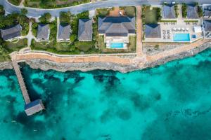 an aerial view of a estate on the water at French Leave Resort, Autograph Collection in Governorʼs Harbour