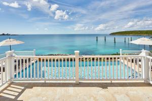 a view of the ocean from a white fence at French Leave Resort, Autograph Collection in Governorʼs Harbour