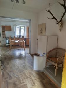 a kitchen and living room with a refrigerator and a table at Ubytování v Horách in Jeseník +2 photos