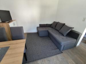 a living room with a couch and a tv at Eva's Ferienwohnung in Altaussee