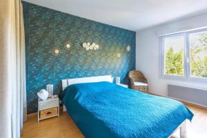 a bedroom with a blue bed and a window at Villa Repose by Villa Plus in Argeliers +15 photos