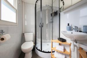 a bathroom with a shower and a toilet and a sink at 27, Beekse Bergen, Efteling, Woods, Private Parking! in Oisterwijk
