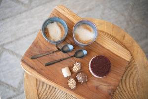 two cups of coffee on a wooden cutting board at 27, Beekse Bergen, Efteling, Woods, Private Parking! in Oisterwijk +23 photos