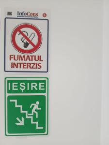 a sign with a no smoking sign and a sign that says uranium interns at Elizabeth's Rooms in Gherla